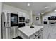This kitchen features stainless appliances, island and view of the living room at 2678 Adair Trl, Dacula, GA 30019