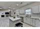 Modern kitchen has quartz countertops, stainless appliances and adjoins large living area at 2678 Adair Trl, Dacula, GA 30019