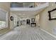 An open-concept design connects the living room, kitchen, and dining area, all with matching light-colored wood-look floors at 2678 Adair Trl, Dacula, GA 30019