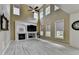Open living room featuring a fireplace, lots of windows, high ceilings, and light-colored wood-look floors at 2678 Adair Trl, Dacula, GA 30019