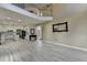 Wide angle view of open concept living area showing light-colored wood-look floors, and view to kitchen and front door at 2678 Adair Trl, Dacula, GA 30019