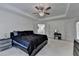 Spacious main bedroom with neutral carpet, tray ceiling, and door to the main bathroom at 2678 Adair Trl, Dacula, GA 30019