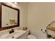 A neutral powder room with a traditional mirror and a single sink vanity at 2678 Adair Trl, Dacula, GA 30019