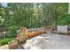Large backyard with a white picket fence and a concrete patio area perfect for gardening at 2700 White Blossom Ln, Suwanee, GA 30024