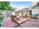 Cozy backyard featuring brick patio, deck with a gazebo, fire pit, and convenient storage shed at 2700 White Blossom Ln, Suwanee, GA 30024