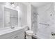 Updated bathroom features a marble look shower with grab bars, new toilet and vanity at 2700 White Blossom Ln, Suwanee, GA 30024