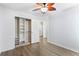 Bedroom view with closet featuring organizers and wood-look flooring throughout at 2700 White Blossom Ln, Suwanee, GA 30024