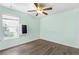 Cozy bedroom featuring a ceiling fan, neutral paint, and hardwood floors at 2700 White Blossom Ln, Suwanee, GA 30024
