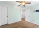 Bedroom with ceiling fan, hardwood floors, and ample closet space at 2700 White Blossom Ln, Suwanee, GA 30024