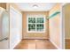 Sunny dining area with hardwood floors, a large window, and a view to the yard at 2700 White Blossom Ln, Suwanee, GA 30024