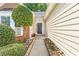 View of front door with stone pathway, manicured bushes and well maintained lawn at 2700 White Blossom Ln, Suwanee, GA 30024
