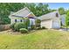 View of lovely home with well-manicured lawn, garden and shrubbery at 2700 White Blossom Ln, Suwanee, GA 30024