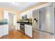 Well-lit kitchen with stainless steel appliances, granite countertops, and views to other rooms at 2700 White Blossom Ln, Suwanee, GA 30024