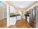 Updated kitchen featuring stainless steel appliances, granite countertops, and white cabinetry at 2700 White Blossom Ln, Suwanee, GA 30024