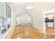 Living room showcasing hardwood floors, a window, and open access to the kitchen with stainless steel appliances at 2700 White Blossom Ln, Suwanee, GA 30024