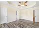 The primary bedroom features a tray ceiling, ceiling fan and a door to the primary bathroom at 2700 White Blossom Ln, Suwanee, GA 30024