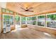 Bright sunroom featuring all wood ceiling and floor, with many surrounding windows at 2700 White Blossom Ln, Suwanee, GA 30024