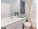 Bright bathroom featuring a white vanity, framed mirror, and a shower with white shower curtain at 5595 Rosehall Pl, Atlanta, GA 30349