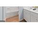 Well-lit bathroom with a white vanity, countertop, and modern fixtures at 5595 Rosehall Pl, Atlanta, GA 30349