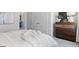 Neutral primary bedroom showcasing a queen-sized bed and a wooden dresser, with a minimalist aesthetic at 5595 Rosehall Pl, Atlanta, GA 30349