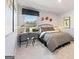 Stylish bedroom with a bed, desk, and a large window offering natural light at 5595 Rosehall Pl, Atlanta, GA 30349