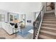Spacious living room with a fireplace, hardwood floors, and a staircase at 5595 Rosehall Pl, Atlanta, GA 30349