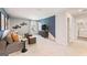 Modern living room with a comfortable sofa, accent wall, and stylish decor at 5595 Rosehall Pl, Atlanta, GA 30349