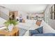 Bright living room with a white sofa, decor, and connecting to the kitchen area at 5595 Rosehall Pl, Atlanta, GA 30349