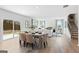 Open-concept living and dining area with hardwood floors, flowing into a modern kitchen and staircase at 5595 Rosehall Pl, Atlanta, GA 30349