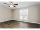 Bedroom featuring hardwood flooring, a ceiling fan, and a window with bright natural light at 820 Tradd Ct, Stone Mountain, GA 30087