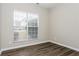 Bright bedroom featuring new hardwood flooring and a window that lets in natural light at 820 Tradd Ct, Stone Mountain, GA 30087