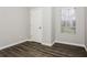 Neutral bedroom featuring modern flooring, a window for natural light, and closet at 820 Tradd Ct, Stone Mountain, GA 30087