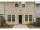 Back exterior of the home showcases the outdoor patio, yard and windows at 1341 Rogers Trce, Lithonia, GA 30058