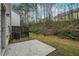 Large backyard with concrete patio, wood fence and plentiful shade trees at 1341 Rogers Trce, Lithonia, GA 30058