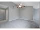 Spacious bedroom with neutral paint, carpeted floor, ceiling fan and connecting hallway at 1341 Rogers Trce, Lithonia, GA 30058