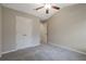 Bedroom with carpeting, a ceiling fan, and a closet, ideal for relaxation and storage at 1341 Rogers Trce, Lithonia, GA 30058