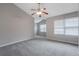 Bright bedroom with vaulted ceilings, a ceiling fan, carpeted floor, and large windows at 1341 Rogers Trce, Lithonia, GA 30058