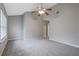 Bright bedroom featuring a ceiling fan, carpeted floor and a window providing natural light at 1341 Rogers Trce, Lithonia, GA 30058
