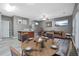 Dining area with seating for four, open to the living room and kitchen, with grey hardwood-style flooring at 1341 Rogers Trce, Lithonia, GA 30058