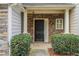 Close-up of the front entryway with a stone facade, columns, and a dark-colored front door at 1341 Rogers Trce, Lithonia, GA 30058