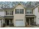 Attractive townhome with shake siding, shutters, and stone accents at the front entryway and garage at 1341 Rogers Trce, Lithonia, GA 30058