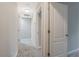 Hallway with neutral carpet, white doors, and access to multiple rooms in the home at 1341 Rogers Trce, Lithonia, GA 30058