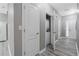 Hallway with white doors and grey walls, includes a laundry area with a stacked washer and dryer at 1341 Rogers Trce, Lithonia, GA 30058