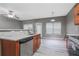 Open concept kitchen with stainless steel appliances, white counters and wood-look flooring at 1341 Rogers Trce, Lithonia, GA 30058