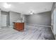 Open concept living room with wood-look flooring, adjacent to the kitchen at 1341 Rogers Trce, Lithonia, GA 30058
