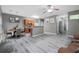 Spacious open-concept living room with dining and kitchen areas; features grey hardwood-style flooring at 1341 Rogers Trce, Lithonia, GA 30058