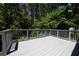 Relax on this outdoor deck overlooking a serene wooded backyard, perfect for peaceful retreat at 535 Toonigh Rd, Woodstock, GA 30188