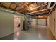 Unfinished basement with exposed ductwork, leading to stairway and a garage entrance to the home at 535 Toonigh Rd, Woodstock, GA 30188