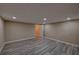 Finished basement featuring modern flooring, neutral walls, and recessed lighting at 535 Toonigh Rd, Woodstock, GA 30188
