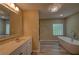 Bathroom featuring a freestanding tub, modern fixtures, and neutral tones at 535 Toonigh Rd, Woodstock, GA 30188
